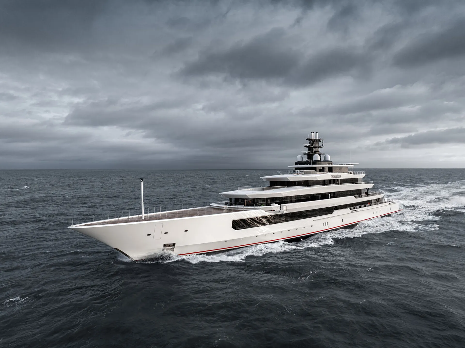 DreAMBoat (90m, Oceanco 2019) underway under a heavy sky, Espen Oeino exterior with her red boot stripe